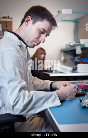 Engineer testing a circuit board assembly Stock Photo
