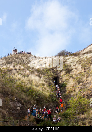 Waikiki, HI - JANUARY 15: Tourists climbing to summit of Diamond Head crater on January 15, 2012. The path gains 560 feet from the crater floor. Stock Photo