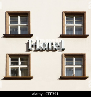 Wall of hotel close-up with windows and singboard Stock Photo