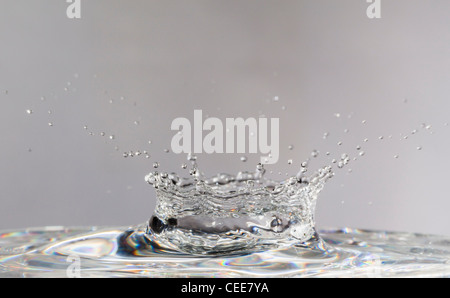 Shapes created by falling water droplets, frozen with high-speed flash, forming a classic crown Stock Photo