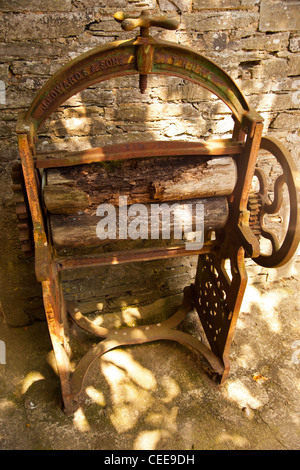 rusty old mangle in country house grounds, old fashioned washing machine,washing machine uses no electricity,eco washing machine Stock Photo