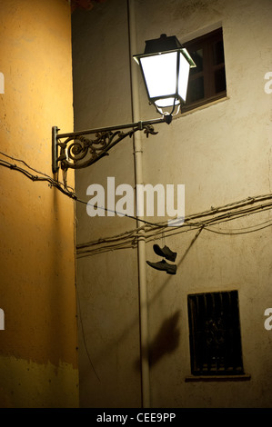 Shoes hanging from an electric wire, Albaicin, Granada, Spain Stock Photo