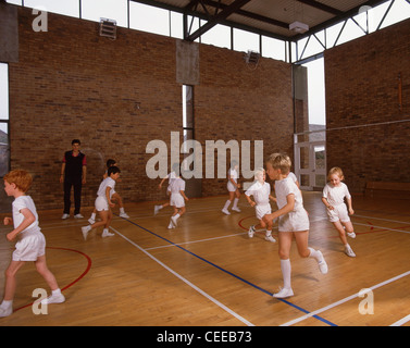 School children excercising in gym, Surrey, England, United Kingdom Stock Photo