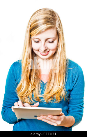 blond teenager girl using an iPad tablet computer Stock Photo