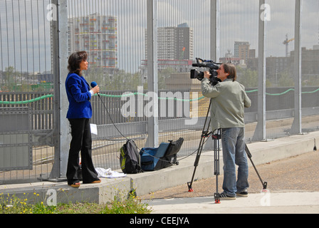 Female television presenter doing piece to camera Stock Photo