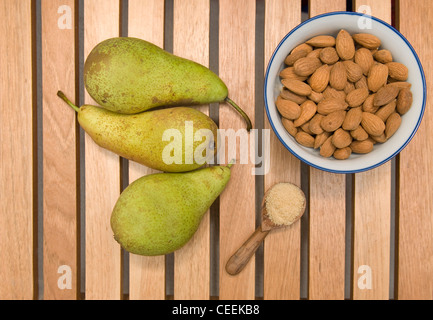 Pears sugar and almonds on a wooden tray Stock Photo