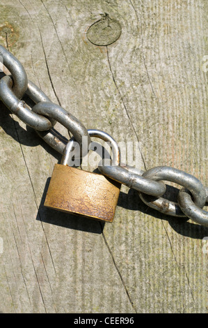 Padlock and Chain on Wooden Farm Gate Stock Photo