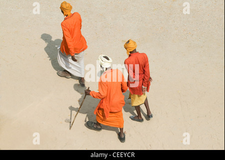 Three Indian man talk with each other on the street, Pushkar, Rajasthan, India Stock Photo