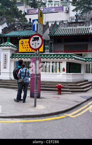 dh Man Mo Temple SHEUNG WAN HONG KONG Tourist couple reading information board china young holiday asia Stock Photo