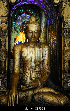 statue statues buddha buddhist gold leaf cover covered buddhism Shwedagon Pagoda Myanmar Burma Yangon Rangoon Stock Photo