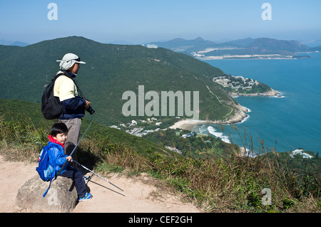 dh Shek o Country park DRAGONS BACK HONG KONG Chinese man boy on footpath Big Wave Bay people landscape china Stock Photo