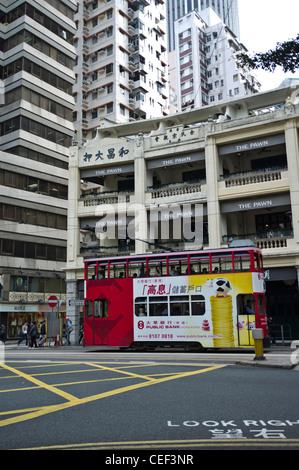 dh  WAN CHAI HONG KONG The Pawn Restaurant Old chinese building Tram with adverts Stock Photo