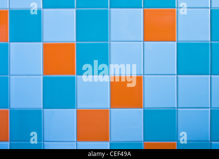 Part of wall in modern bathroom with tiles in light blue, azure blue and orange Stock Photo