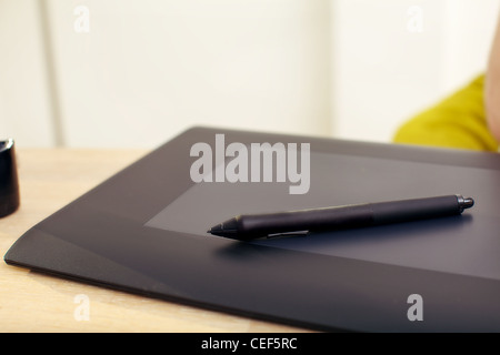 Clsoeup of a graphics tablet and pen on a desk. Stock Photo