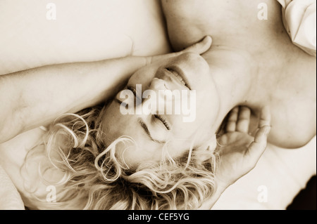 The enraptured face of a woman close-up while she is having a massage. Stock Photo