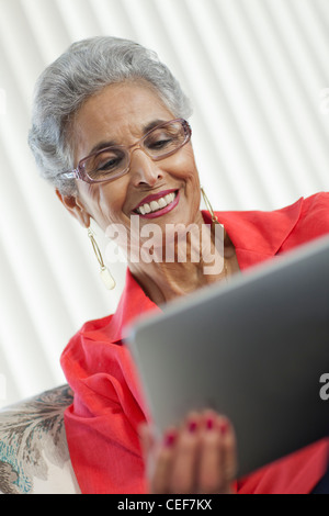 Stylish senior Black woman using a digital tablet Stock Photo