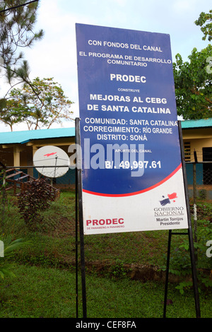 Sign outside school promoting development projects funded by payments from the Panama Canal, Santa Catalina, Veraguas Province, Panama Stock Photo