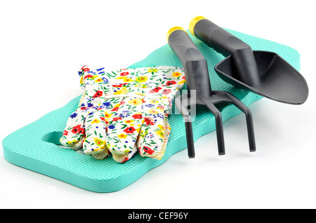 Getting ready for spring - kneeling pad, gloves and hand gardening tools on white background in horizontal format Stock Photo