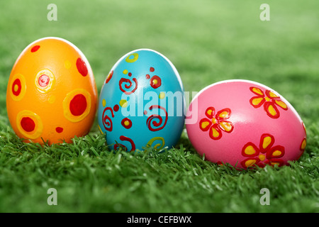 Three easter eggs lying on the lawn Stock Photo