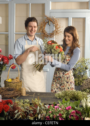 Florists arranging bouquet in shop Stock Photo