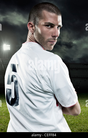 Soccer player looking over his shoulder Stock Photo