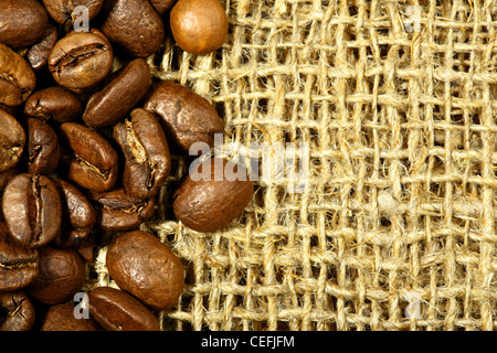 Coffee beans on sacking and space for your own text on right Stock Photo