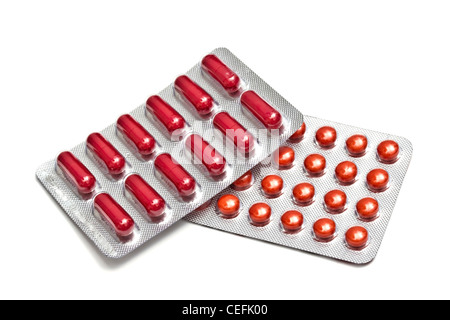 Red pills and capsules isolated on white background Stock Photo