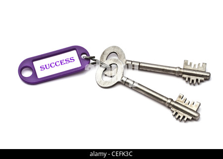 Key with a success tag closeup on white background Stock Photo