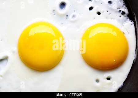 Two fried eggs on pan close up Stock Photo
