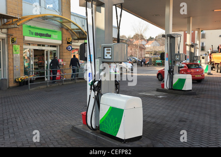 Fuel pumps on a BP filling station forecourt with Co-operative shop convenience store. UK Britain Stock Photo