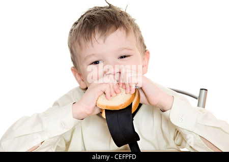 thoughtful boy eating a sandwich with his tie Stock Photo