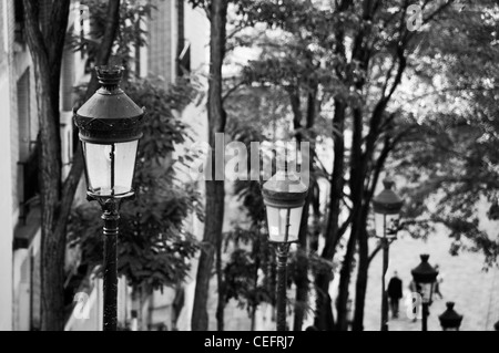 Citylights in a sloping street of the Butte montmartre, Paris - France Black and white. Stock Photo