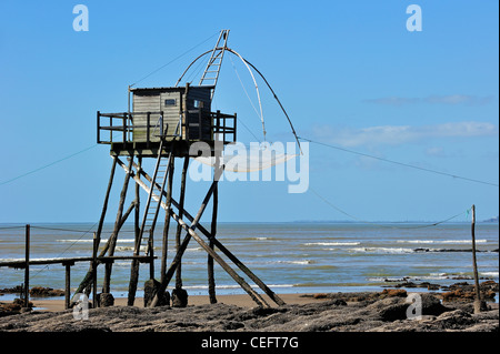 Traditional carrelet fishing hut with lift net on beach at Saint-Michel-Chef-Chef, Loire-Atlantique, Pays-de-la-Loire, France Stock Photo