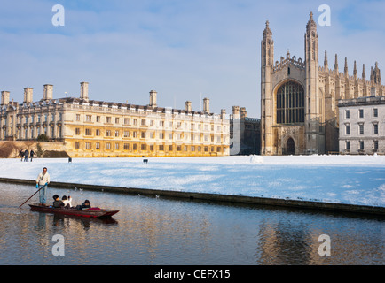 Punting along river Cam in winter snow with Kings College Chapel to the rear. Cambridge, England.