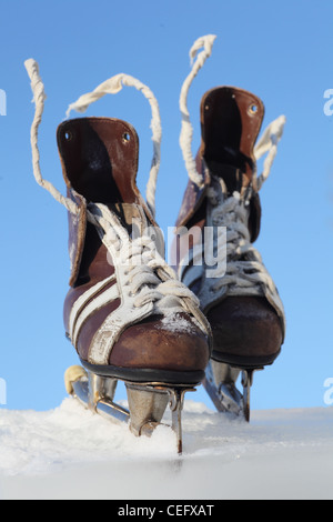 vintage pair of mens skates on the ice Stock Photo