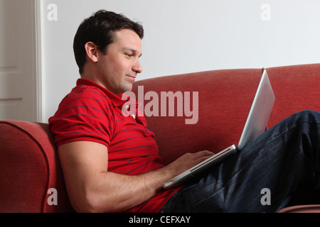 Profile of a single man using a laptop. Stock Photo