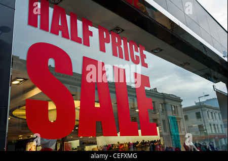 Half price sale sign in a shop window. Stock Photo