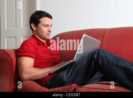 Profile of a single man using a laptop.