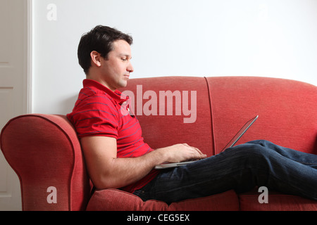 Profile of a single man using a laptop.