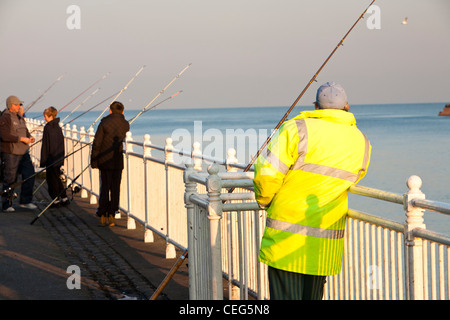 Fisherman sea fishing at Wearmouth in Sunderland, UK. Stock Photo