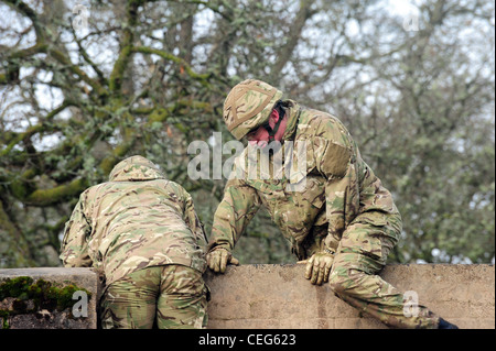 Members from The Prince of Wales' Company, 1st Battalion Welsh Guards, going over the assault course February 2012 at Sennybridg