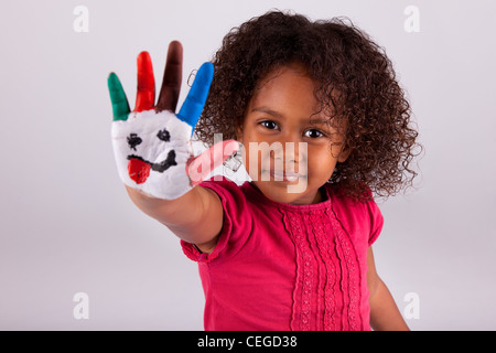 Little African Asian girl with painted hands in colorful paints Stock Photo