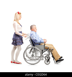 Full length portrait of a daughter pushing her dad in a wheelchair isolated on white background Stock Photo