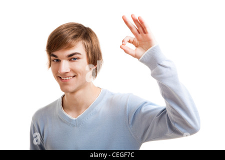 Portrait of a handsome young man doing a Okay gesture, isolated over a white background Stock Photo