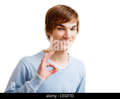 Portrait of a handsome young man doing a Okay gesture, isolated over a white background Stock Photo