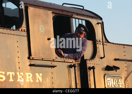 Train driver looking out of steam engine on the Severn Valley Railway Kidderminster Worcs UK Stock Photo