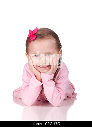 Image of a cute child laying down with her hands under her chin. Stock Photo