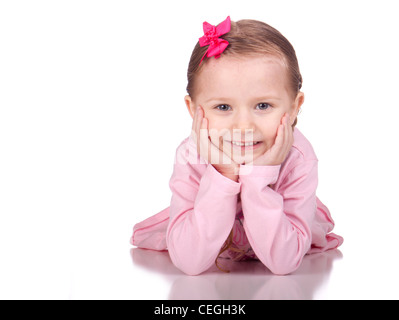 Image of a cute child laying down with her hands under her chin. Stock Photo