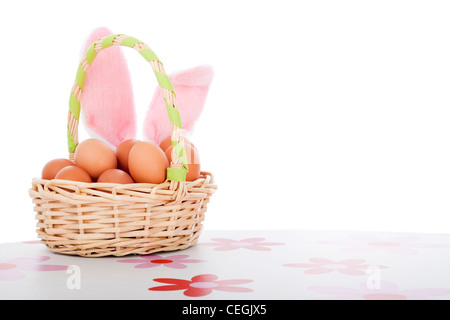 Easter basket with eggs and bunny ears, Easter decoration background with copy space, isolated on white background. Stock Photo