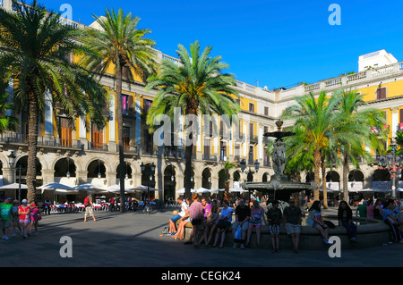 People enjoy the evening sun on Placa Reial in Barcelona, Spain. Stock Photo